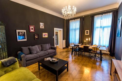 a living room with a couch and a table at R38 - Artists luxury home in Budapest