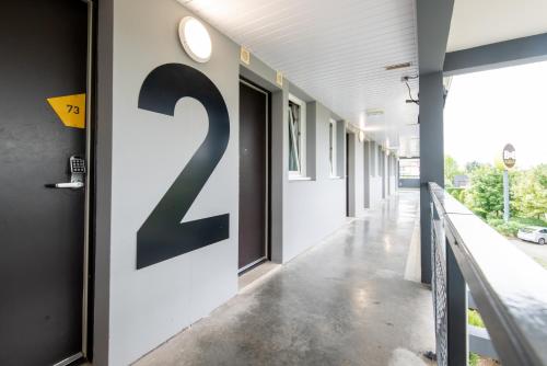a hallway of an empty building with a number z on the wall at B&B HOTEL Dieppe in Saint-Aubin-sur-Scie