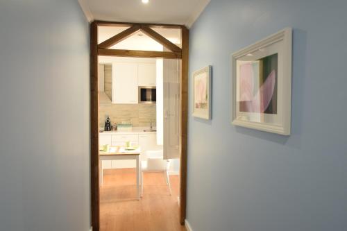 a hallway leading to a kitchen with a dining room at Lx Flowers Apartments in Lisbon
