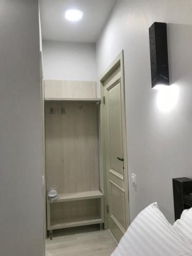 a bedroom with a walk in closet and a bed at Moonlight Hotel in Chişinău