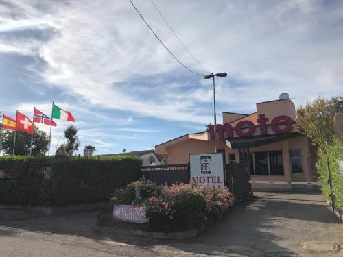 a hotel with flags in front of a building at Hotel Motel Regal in Vermezzo