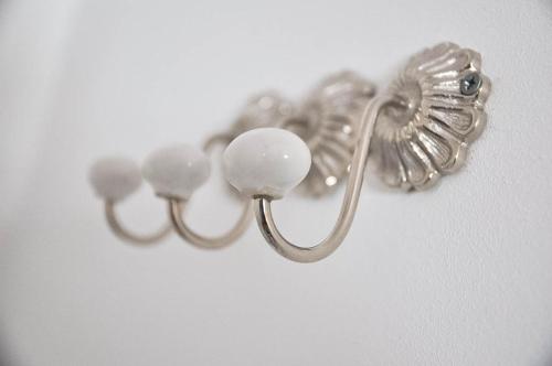 a bunch of silver earrings hanging on a wall at bensons hotel in Aachen