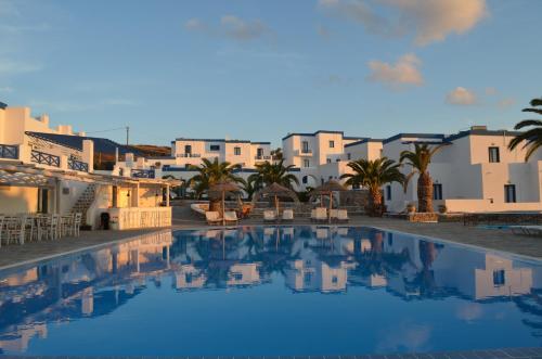 a view of a swimming pool with buildings in the background at Faros Resort in Azolimnos