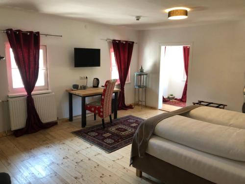 a bedroom with a bed and a table and a desk at Fenix Hall Boutique Hotel Hallstatt in Hallstatt
