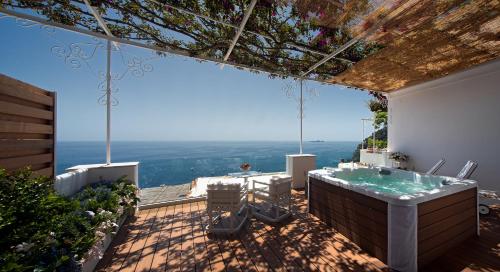 a bathroom with a bath tub on a patio at Hotel Montemare in Positano
