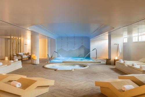 a bathroom with a tub in the middle of a room at Luna Park Hotel Yoga & Spa in Malgrat de Mar