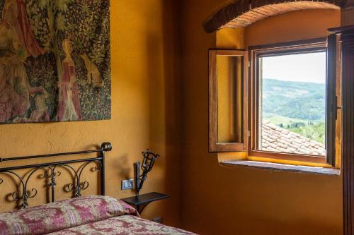 a bedroom with a bed and a window at La Rimbecca Greve in Chianti in Greve in Chianti