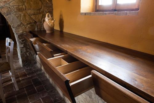 a wooden counter in a room with stairs at La Rimbecca Greve in Chianti in Greve in Chianti