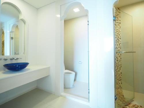 a bathroom with a sink and a glass shower at Marrakesh Huahin in Hua Hin