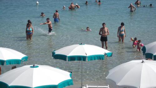 a group of people in the water at a beach at Bilocale Punta Rosa - Fronte Spiaggia in Otranto