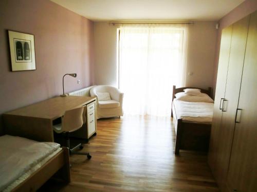 a room with a desk and a bed and a window at Pension Rondel in Poděbrady