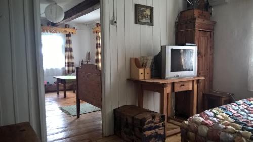 a room with a bed and a tv on a table at Kačiūniškis in Kaciūniškiai