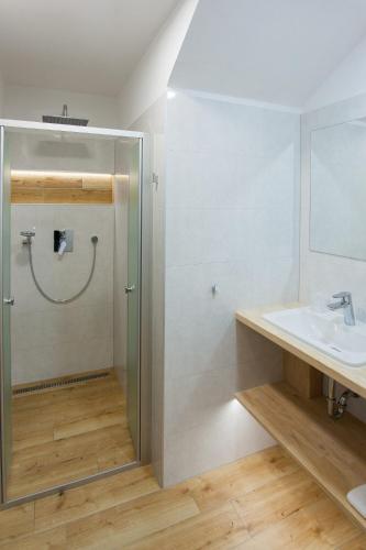 a bathroom with a shower and a sink at Resort-Restaurant Stilec in Kamenný Újezd