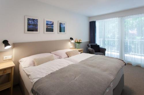 a bedroom with a large bed and a window at Resort-Restaurant Stilec in Kamenný Újezd