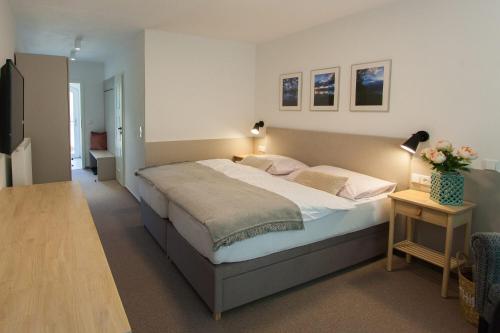 a bedroom with a large bed with two pillows at Resort-Restaurant Stilec in Kamenný Újezd