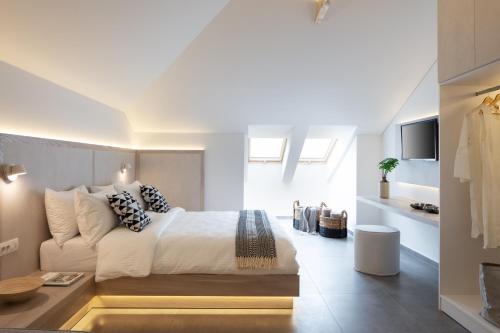 a bedroom with a bed and a living room at Hotel Rezi in Parga