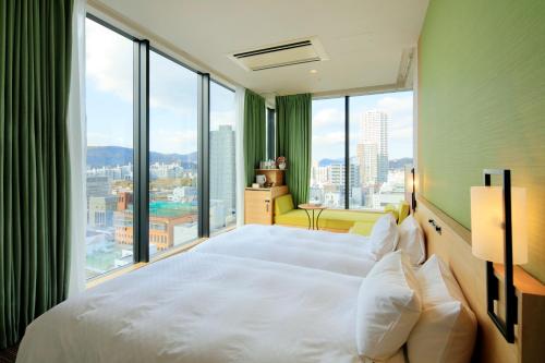 a hotel room with a large window overlooking the ocean at Candeo Hotels Hiroshima Hatchobori in Hiroshima