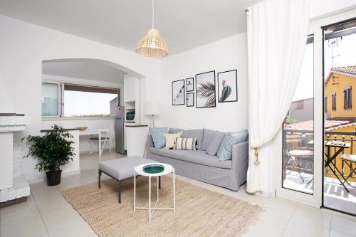 a white living room with a couch and a table at Villa Elisabetta Apartments in Pula