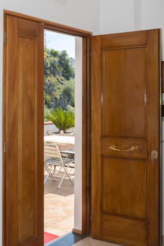 an open wooden door with a view of a patio at "CASALENA" Villa a Furore Amalfi coast con grande terrazzo e vista sul MARE in Furore