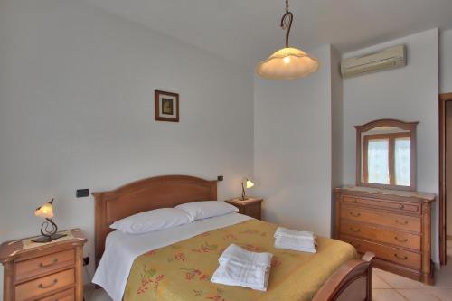 a bedroom with a bed with two towels on it at "CASALENA" Villa a Furore Amalfi coast con grande terrazzo e vista sul MARE in Furore