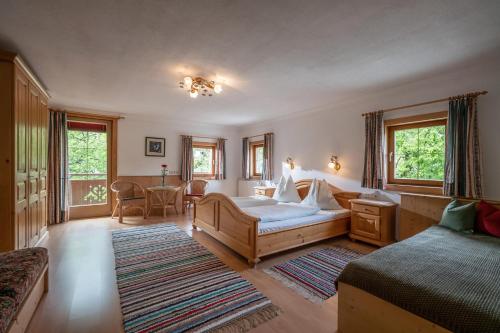 a bedroom with two beds and a table and chairs at Tuxerhof in Hippach
