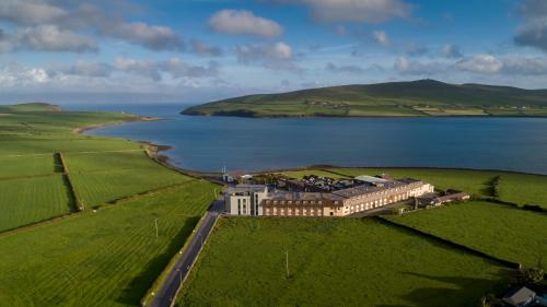 an aerial view of a building next to a body of water at Dingle Skellig Hotel in Dingle