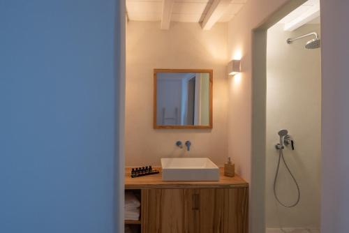 a bathroom with a sink and a mirror at The Summit of Mykonos in Kalo Livadi