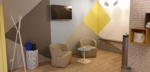 a living room with two chairs and a table at Mercure Marseille Centre Vieux Port in Marseille