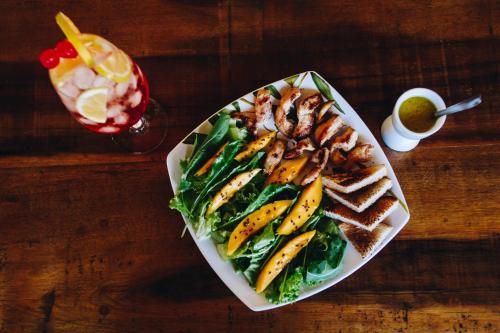 a plate of food on a wooden table at Hotel Fita Azul in Ilhabela