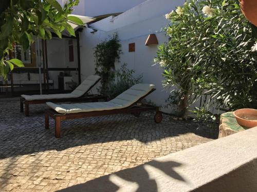 a chair and a couch sitting in a patio at Casa da Galega in Golegã
