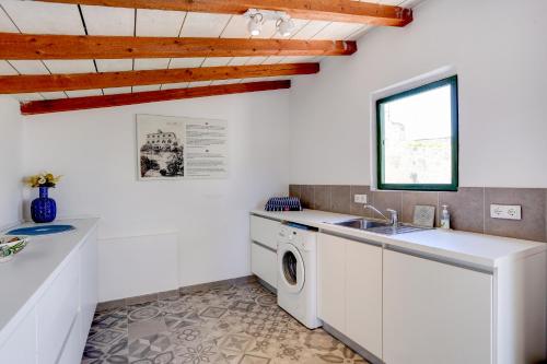 a kitchen with a washing machine and a sink at Villa Marchi in Hvar