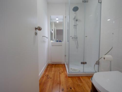 a bathroom with a shower with a glass door at Fanqueiros 196 - Center City Apt in Lisbon