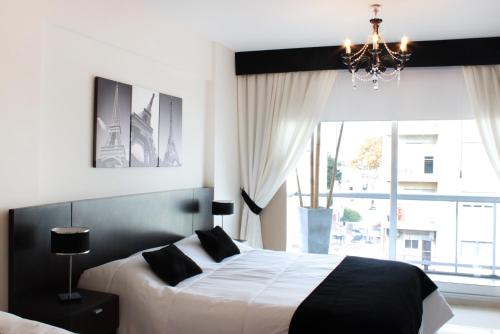En eller flere senge i et værelse på Hotel Boutique Devoto