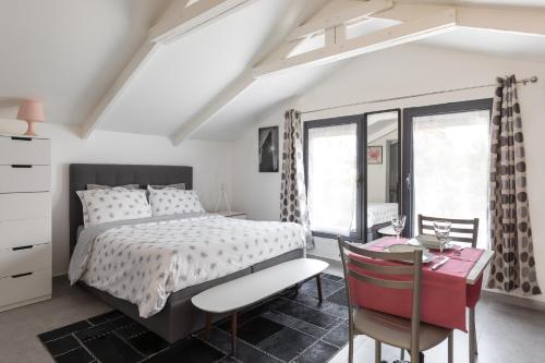 a bedroom with a bed and a table and chairs at Trendy studios Tassin in Tassin-la-Demi-Lune