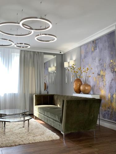 a living room with a couch and a table at Boutique Hotel Center in Kecskemét