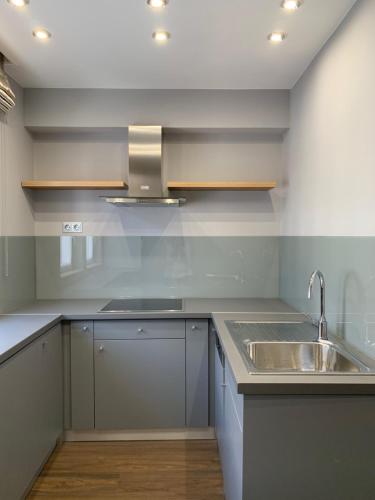 a kitchen with a sink and a counter top at Boutique Hotel Center in Kecskemét