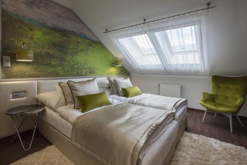 a bedroom with a large bed and a green wall at Boutique Hotel Center in Kecskemét