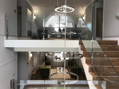 a glass staircase with two tables in a room at Boutique Hotel Center in Kecskemét