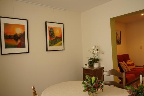 a living room with a table and a red couch at RectoVersoVV in Sint-Pieters-Leeuw