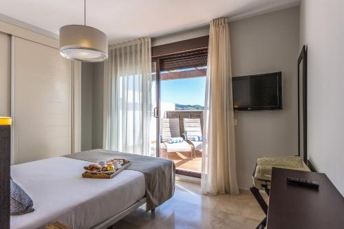 Säng eller sängar i ett rum på Ona Valle Romano Golf & Resort
