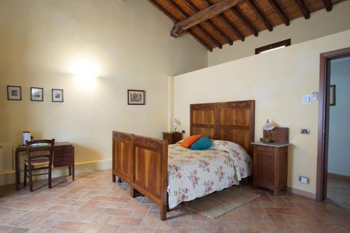 a bedroom with a bed and a desk and a chair at Agriturismo Aggazzotti in Colombaro