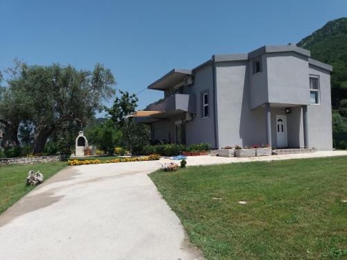 a house with a walkway in front of a yard at Zelena Maslina in Bar