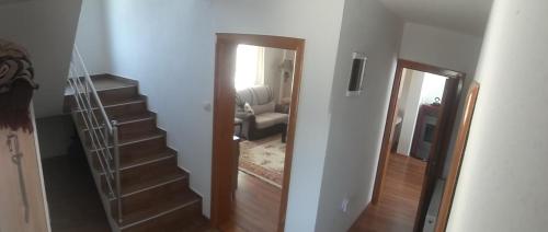 a hallway with a stairway leading to a living room at Zelena Maslina in Bar