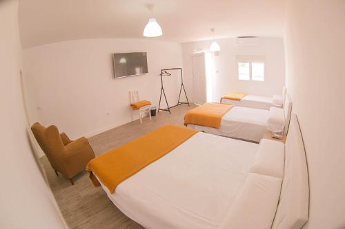 a hospital room with two beds and a tv at Hostal el Pinar Cadiz in Puerto Real