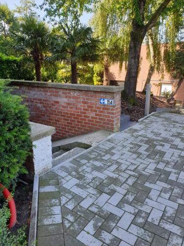 a brick retaining wall and a stone patio at Homestay Gent-Merelbeke self check-in service in Ghent