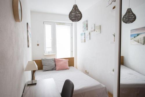 a small room with a bed and a mirror at Cozy apartment btw centre and airport - Private host - No invoice in Bratislava