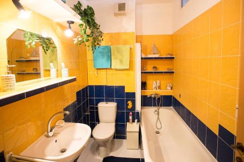 a bathroom with a tub and a toilet and a sink at Cozy apartment btw centre and airport - Private host - No invoice in Bratislava