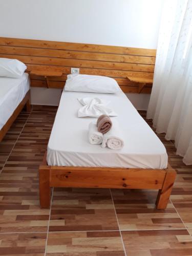 a bedroom with a bed with towels on it at Beleris Rooms in Himare