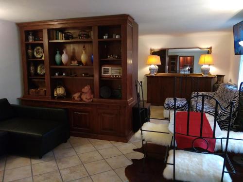a living room with a couch and a entertainment center at Suite Bobo relax nel chianti classico gallo nero in Strada