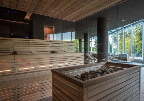 a large room with a large tub with logs in it at Terme Preistoriche Resort & Spa in Montegrotto Terme